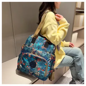 Detail of floral canvas backpack with side pocket and zipper on modern female model