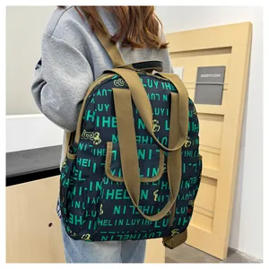 Detail of waterproof backpack with letter print and adjustable brown shoulder straps