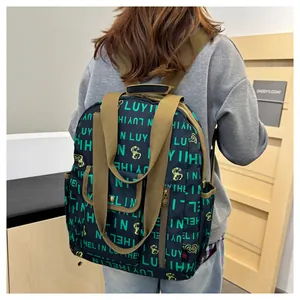 Detail view of large waterproof backpack with letter print and yellow cartoon design