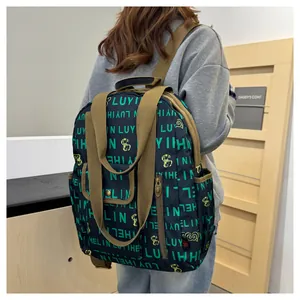 Detail of waterproof nylon backpack with letter print and adjustable khaki shoulder straps