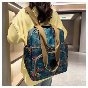 Detail view of versatile backpack with floral print and adjustable straps on model