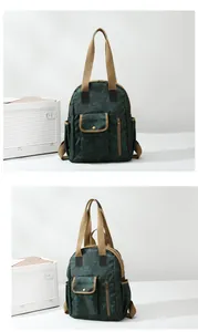 Detail view of a waterproof retro dark green backpack with vintage floral and bamboo patterns
