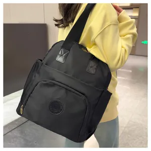 Detail view of the durable nylon backpack with side pockets on a model wearing yellow