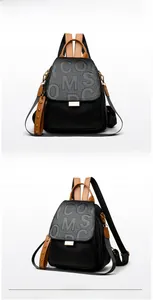Detailed view of the punk rivet backpack featuring COMS embossed letters and metal studs
