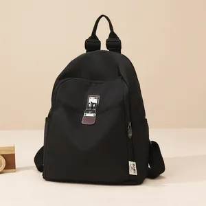 Minimalist black nylon backpack with metal twist-lock and anti-theft design for women
