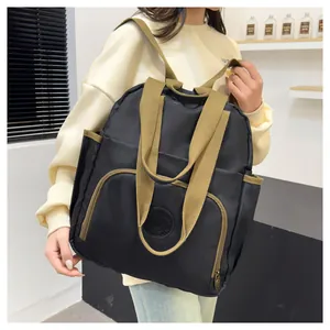 Detail view of the large capacity backpack with olive green straps and round logo