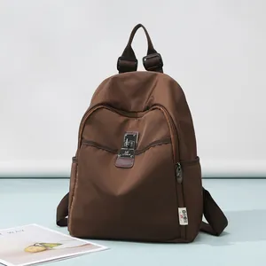 Dark brown literary style anti-theft backpack with metal buckle for student and travel use