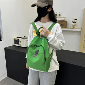Vibrant green nylon backpack with anti-theft lock worn by a model in casual lifestyle setting