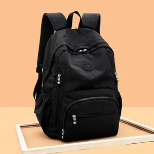 Sac à dos en tissu noir imperméable avec plusieurs poches zippées pour l'école et le voyage