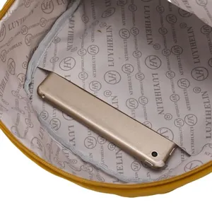 Interior view of yellow backpack showing premium lining, inner pocket and zipper closure