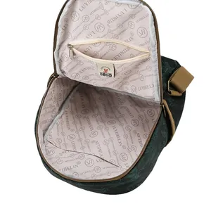 Green vintage backpack with plant patterns showing its spacious internal pocket structure