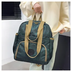Detail of dark green waterproof nylon backpack with floral patterns and woven handles