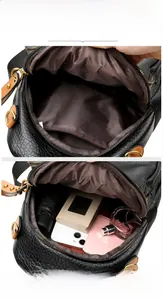 Detailed interior of a black leather backpack showing main pocket and zipper compartment