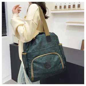 Detail of dark green floral backpack with wide straps and side pocket on model