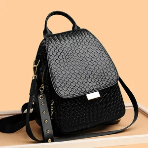 Punk style black woven texture leather backpack with gold rivets and metallic accents
