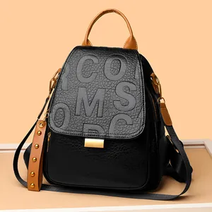 Punk black rivet backpack with embossed letters, brown handle and gold hardware details