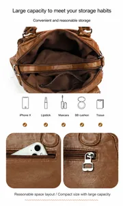 Brown leather boston bag showing large capacity inner compartments and zip detail