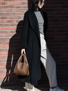 Close-up of brown litchi pattern bucket bag featuring high-quality leather texture