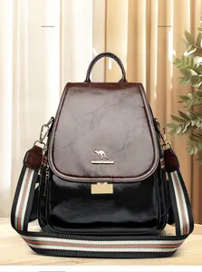 Detail of wax leather backpack featuring contrast colors and striped webbing strap