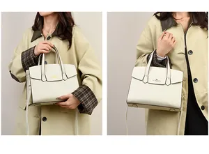 Dettaglio borsa a mano trapezoidale bianco crema con logo a canguro dorato e manico