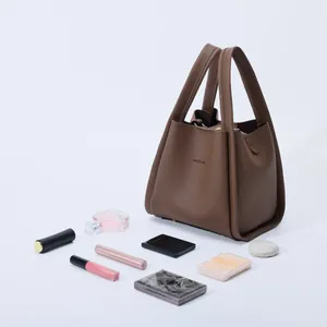 Brown lychee leather bucket bag with HOCOMU logo and cosmetics for storage display