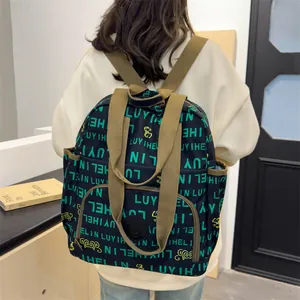 Cool graffiti print nylon backpack with green lettering and durable brown straps
