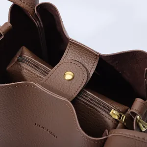 Brown lychee pattern leather bucket bag with inner pouch and magnetic snap closure