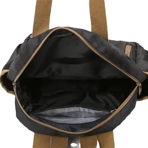 Spacious interior of retro printed backpack showing inner zip pocket and gold hardware