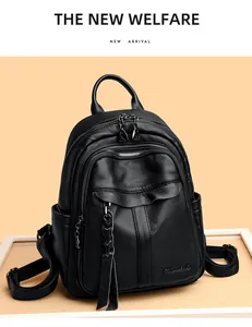 Detailed view of black litchi textured leather backpack with dual zippers and side pocket