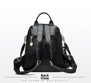 Back view of black faux leather backpack featuring golden studs and safety zipper pocket
