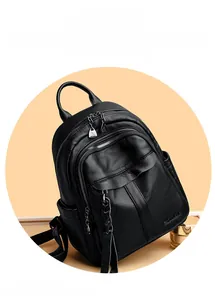 Close-up of black lychee grain leather backpack with woven zipper and side pocket detail