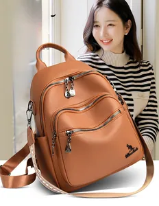 Detail of a brown leather backpack with lychee texture and geometric woven strap