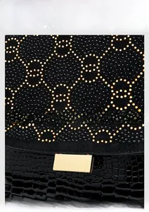 Detail of luxury backpack with sparkling rhinestones and black crocodile embossed leather