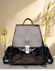 Detail of premium waxed leather backpack showing drawstring closure and metal lock