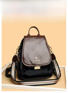 Close-up of the black waxed leather backpack with a colorful stripe strap and golden kangaroo logo