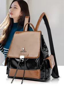 Detail of color-block leather backpack featuring metal buckle and drawstring closure