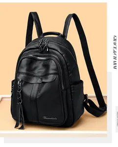 Close-up of black lychee grain leather backpack featuring zipper with fringe tassel
