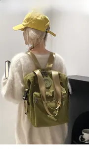Army green waterproof nylon backpack with adjustable side buckles shown on model
