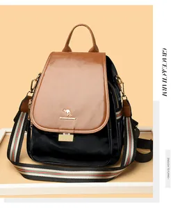 Detail of premium leather backpack featuring a chic brown flap and striped shoulder strap