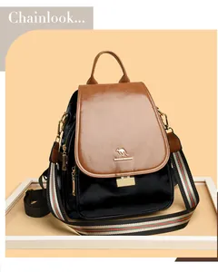 Detail of premium leather backpack featuring a contrast flap and golden kangaroo logo