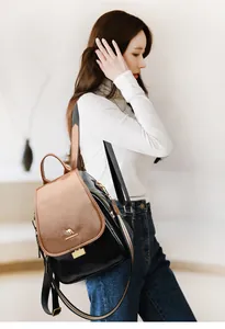Detail of luxury wax leather backpack featuring gold kangaroo logo and colorful stripe straps