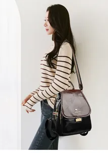 Detail of vintage faux leather backpack with kangaroo logo and colorful stripe strap