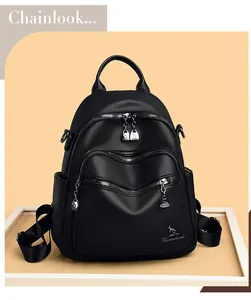 Detailed close-up of premium black litchi pattern leather and multiple zipper pockets