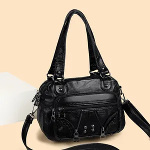 Black washed leather moto bag with silver studs and multi-pocket functional design