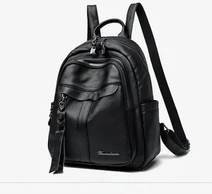 Detail view of black lychee grain texture and Weisendaishu logo on a backpack