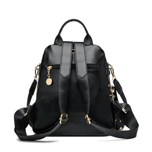 Professional black PU leather punk rivet backpack with gold hardware and rhinestone detail
