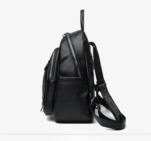 Side view of black lychee grain leather backpack with multiple silver metal zippers