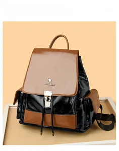 Detail of color-block wax leather backpack with drawstring, kangaroo logo, and anti-theft lock