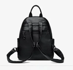 Detail view of the black lychee pattern leather backpack back with anti-theft zipper pocket