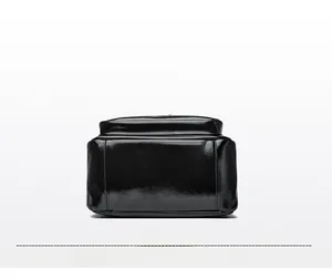 Detailed bottom view of glossy black wax leather backpack with refined stitching details